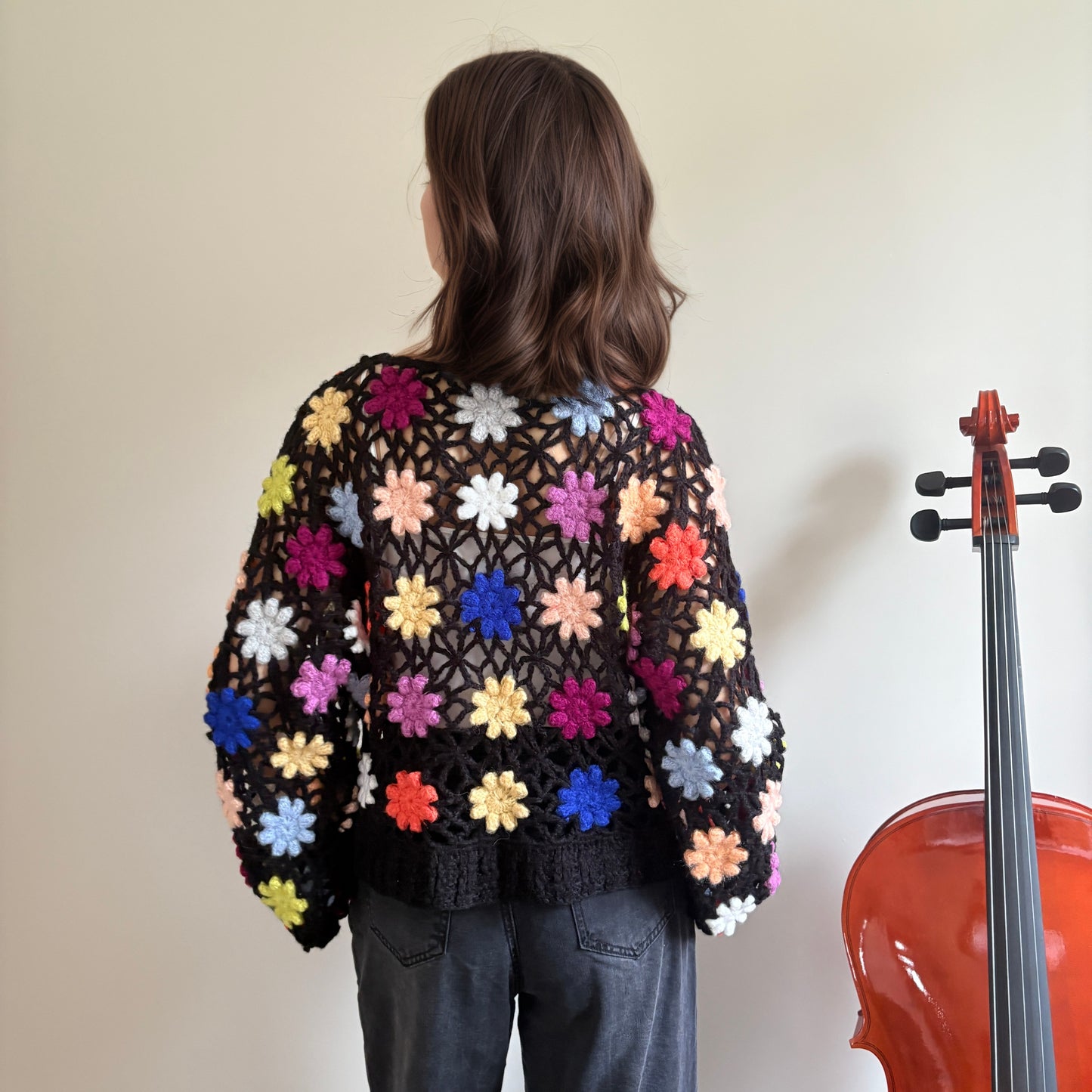 Hand-crocheted knit cardigan with three-dimensional woven flowers