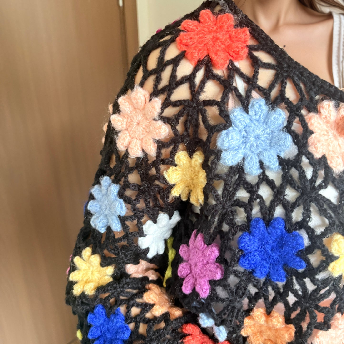 Hand-crocheted knit cardigan with three-dimensional woven flowers